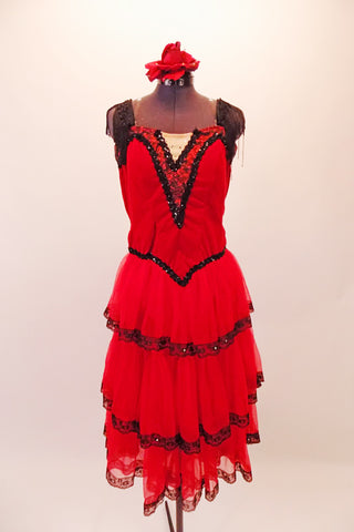 Saloon girl themed, knee-length dress has layers of red, lace-trimmed sheer skirt attached to a red velvet bodice. Black fringe adorns the shoulders and extends along the back Comes with crystalled rose hair accessory. Front