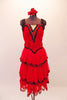 Saloon girl themed, knee-length dress has layers of red, lace-trimmed sheer skirt attached to a red velvet bodice. Black fringe adorns the shoulders and extends along the back Comes with crystalled rose hair accessory. Front