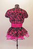 Short unitard has a fuchsia sequined bodice and sold black short with a black sequined waistband. An attached black lace and fuchsia bustle skirt compliments the black lace and fuchsia shrug that ties at front. Comes with a fuchsia floral hair accessory. Back