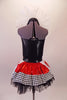 Halter style leotard dress has a large red heart front over a back base with ruffled organza collar. The attached skirt is shiny red with a black & white houndstooth edge over the top of black tulle. Two large white & red heart panels accent each of the hips. Comes with a mini black top hat with a heart accent.  Back
