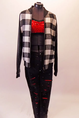 This costume has black shred jeans with a red accent that is covered in scattered crystals. The red sequined bra top accompanies the jeans and sits beneath a black and white plaid jacket with leatherette black and sleeves. Top