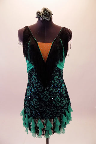 This sassy costume is a black lace and aqua dress with deep plunge front and nude centre inset with crystal accents. Wide black fringe extends from the centre of the bust along the shoulders to the back. Black fringe and ruffled aqua cascade mini ruffles edge the dress. Comes with a floral hair accessory. Front