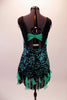 This sassy costume is a black lace and aqua dress with deep plunge front and nude centre inset with crystal accents. Wide black fringe extends from the centre of the bust along the shoulders to the back. Black fringe and ruffled aqua cascade mini ruffles edge the dress. Comes with a floral hair accessory. Back