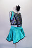 Unique costume has colourful upper composed of sequined panels attached to an aqua short circle skirt with stiffened edging, The back has double cross straps that extend between the shoulder blades. Comes with a floral hair accessory. Side
