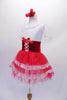 Tutu dress has a white lace bodice with lace neck ruffle and sheer pouffe sleeves. The red velvet wide waistband has a delicate lace-up tie accent at the front. The red triple-layer tulle skirt has a wide lace edging. Comes with a floral hair accessory. Side