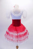 Tutu dress has a white lace bodice with lace neck ruffle and sheer pouffe sleeves. The red velvet wide waistband has a delicate lace-up tie accent at the front. The red triple-layer tulle skirt has a wide lace edging. Comes with a floral hair accessory. Back