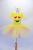 Adorable yellow pleated ballet dress has sheer pouffe sleeves and a large emoji-style happy face on the torso with a crystal-edged neckline. The tutu skirt is yellow with a layer of pale pink beneath. Comes with large yellow hair bow accessory.  Front