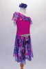 Lovely one-shouldered dress has a fuchsia leotard base with chiffon neck ruffle is shades of blue purple and fuchsia. The attached matching chiffon, knee-length skirt is light and flowy for a nice effect. The pop comes from a gorgeous crystal accessory at the waist. Comes with a large blue floral hair accessory. Right side