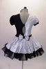 Piano themed dress is silver sequined on right side of bodice & skirt overlay. The left side, single lapel collar & petticoat are black. The costume has colour matched pouffe sleeves. A piano keyboard is appliqued on the left side of the torso. The back is looped with a silver bow. Comes with a bow hair accessory. Back