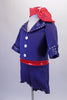 Sweet royal blue short jumpsuit has zip-up back, cuffed ¾ sleeves and lapelled collar accented with crystals. Three large white buttons accent the front of the torso and a crystalled red belt-like waistband gives the costume a pop of colour. Comes with a matching red and white polka dot neck scarf. Side