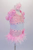 Pink 2-piece costume has a sequined, front gathered bra top. The halter collar & back straps have a 3-D satin-organza rose-ribbon trim. The 3 back straps are covered with large jewel accents. The brief has ostrich feather skirt, jewelled waistband &  floral accent at the hip. Comes with a pink hair accessory. Side
