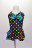Cute colourful, short halter unitard has rainbow polka dots on a black base. Green and blue stripe triple ruffle creates an open front bustle and matches the crystalled banding and large bows at bust and back of the neck. Comes with a hair accessory. Front
