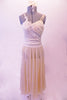 Lovely ivory/cream coloured dress has a long chiffon skirt attached to a sequined-lace and chiffon camisole style leotard. Sequined bridal applique cascades across the front of the torso. Comes with matching hair accessory. Front