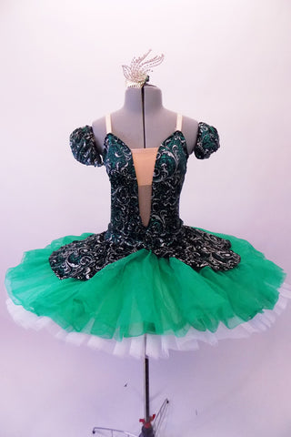 Gorgeous tutu has a dark velvet base with silver & emerald glitter leaf swirl pattern. The bodice has a low plunge front bust area. The low open back has cross straps. The peplum of the skirt overlay sits over layers of sheer emerald poly-chiffon. The crip tulle pull-on tutu is hand stitched but not pleated or hooped. Front