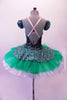 Gorgeous tutu has a dark velvet base with silver & emerald glitter leaf swirl pattern. The bodice has a low plunge front bust area. The low open back has cross straps. The peplum of the skirt overlay sits over layers of sheer emerald poly-chiffon. The crip tulle pull-on tutu is hand stitched but not pleated or hooped. Back