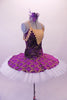 Tutu has a deep purple velvet base with gold brocade design. The bodice has a lined, nude V-front bust area with crystal accents & gold crochet lace edging that extends to form draping shoulder loops. The back has cross straps for support. The overlay skirt with attached basque sits over top of the white pull-on tutu. Side