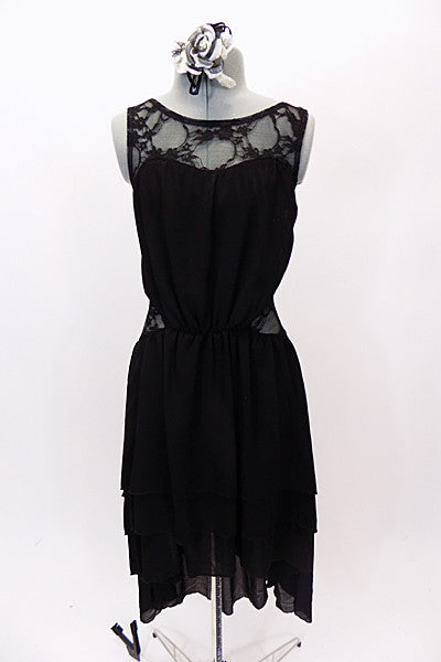 Black high-low layered chiffon dress has lace upper bodice and side inserts. Back is lace and lycra for additional stretch. Comes with floral hair accessory. Front
