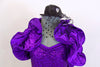 Black and purple sequined short unitard has black dotted tulle hip bustle and removable purple ruffled wrap shrug. Comes with black mini top-hat accessory with dotted mesh veil. Front zoom