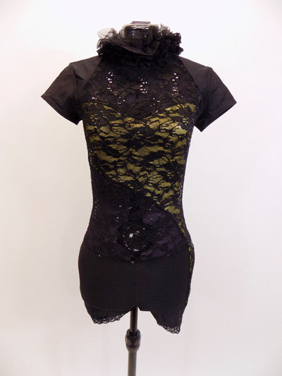 Black sequined lace short unitard has gold underlay and lace accents on leg . Ruffled halter neck reveals an open back. Comes with matching hair accessory. Front