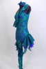 Custom acro unitard of teal lace on an electric blue base has one leg & one shoulder and ruffles across bodice. Right leg is sheer lace with soft ruffles. Comes with custom hair piece. Side