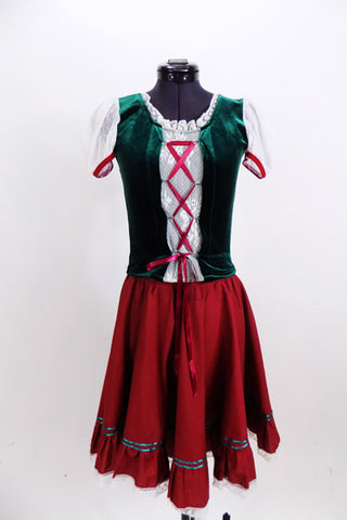 Two piece ballet or character costume has a dark green velvet stretch bodice with lace sleeves & a corset style front. Comes with fuchsia ribbon detailed skirt & floral hair wreath. Front 