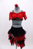 Latin  flare costume has red ruffled off shoulder half-top with black lace band. Skirt has layers of black & red tulle. Has attached panty& matching hair accessory. Front