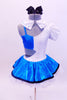 Leotard has one white high neck open side joined to a bright turquoise half-top.There is a skirt,  black glasses,  hair bow & crystal covered “Jane” name tag.  Back