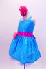 Sparkle- lycra turquoise halter dress has bright pink crystal covered waistband with pink flower and matching bottoms. Comes with matching pink floral hair accessory. Side