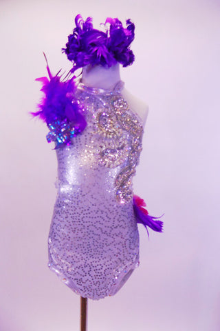 White sequined halter leotard has large crystal sequined appliques along left front bodice. Purple feathers and a hot pink ruffle cover from the left hip around the back.  There is a purple sequined and feather accest in the right shoulder. Comes with purple feather hair accessory. Front