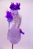 White sequined halter leotard has large crystal sequined appliques along left front bodice. Purple feathers and a hot pink ruffle cover from the left hip around the back.  There is a purple sequined and feather accest in the right shoulder. Comes with purple feather hair accessory. Front