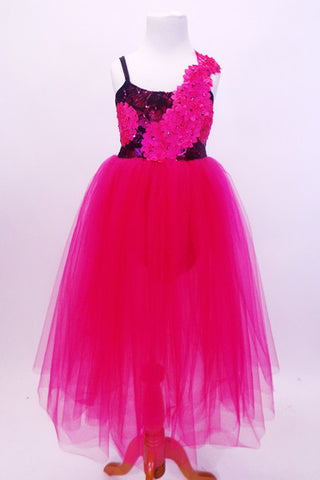 Layers of long fuchsia tulle make up the skirt of this black lace ballet dress adorned with satin fuchsia Gerbera flowers and matching hair accessory. Front