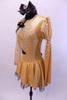 Gold long sleeved dress had one pouf & one sheer gold mesh sleeve & shoulder. Oriental style collar & piping. Has large black bow on back & black hair bow. Left Side