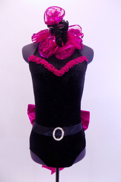 Black high neck halter leotard has collar of hot pink sequined roses. There is a large pink bow on behind. Has longs black gloves and matching hair accessory. Front