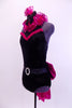 Black high neck halter leotard has collar of hot pink sequined roses. There is a large pink bow on behind. Has longs black gloves and matching hair accessory, Side