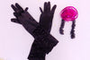 Black high neck halter leotard has collar of hot pink sequined roses. There is a large pink bow on behind. Has longs black gloves and matching hair accessory. Gloves and hair accessory