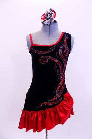 One shoulder black leotard dress has red piping with custom hand painted red and silver flames across the top and cascading down the entire left side.  There is a wide satin ruffle along the bottom edge of the skirt that comes up higher at the left hip.  Costume comes with matching black-silver-red hair accessory. Front
