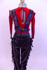 Red tank style leotard  is accompanied by, leather-like pants with fringes & studded belt.Leather strapped vest sits on top of red leotard. Matching hair piece. Back
