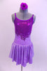 Pale lavender marble  leotard dress has purple glitter front bodice and low open back with cross straps.  A purple glitter swirled applique accent surrounds the glittery bodice. Comes with matching hair accessory. Front