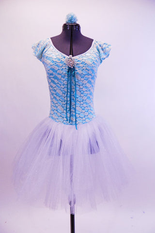 Knit stretch lace covers an aqua base on this two tone leotard tutu dress with ruffle cap sleeves. The front and back are scoop neck with a front crystal broach and ribbon accent. The attached tutu skirt is comprised of several  layers of white crystal tulle. Comes with matching hair accessory. Front