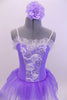 Pale lavender leotard dress has white ribbon rose detailed front bodice. The attached skirt is lavender organza that sits on layers of white tulle.  Comes with matching hair accessory. Front zoomed