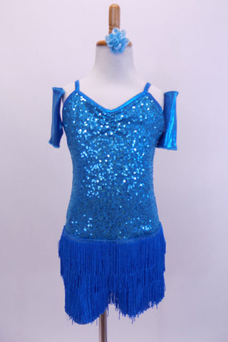 Camisole style turquoise sequined flapper dress has layers of blue fringe attached at hip. Comes with wrist gauntlets and a matching floral hair accessory. Front