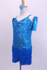 Camisole style turquoise sequined flapper dress has layers of blue fringe attached at hip. Comes with wrist gauntlets and a matching floral hair accessory. Side