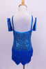 Camisole style turquoise sequined flapper dress has layers of blue fringe attached at hip. Comes with wrist gauntlets and a matching floral hair accessory. Back