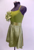  Olive coloured camisole leotard dress has satin skirt and satin sash. There is a large soft organza flower on the upper right side of the bodice. Very simple, and soft. Comes with crystal barrette hair accessory. Left Side