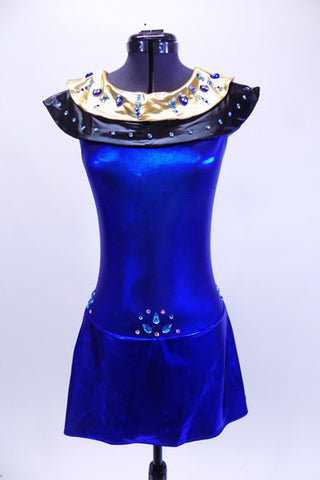 Electric blue halter leotard dress has attached Egyptian style gold and black, jewel/crystal covered collar . There are also jewels and Swarovski crystals at front and sides of waistline. Dress has an open back, attached box skirt and large gold sequined applique at lower back. Front