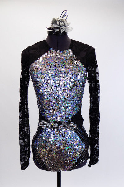 Long sleeved leotard has lace back and sleeves. The brief portion is silver with a black mesh overlay. The front of the leotard is covered in iridescent sequins and has a large jeweled belt which snaps at the back. Comes with a silver and black hair accessory. Front