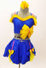 Blue bra top with yellow ruffle & large bow accent. The matching skirt is a blue overlay with  of yellow  petticoat & bows accents. Has floral hair accessory. Front