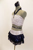 White & silver sequin bandeau bra top has front loop with navy halter collar. The briefs are separate from navy sequined lace skirt. Comes with hair accessory. Side