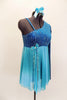 Turquoise glitter-velvet, one shoulder A-line dress with single long sleeve, has soft chiffon draping extending to wrist. Chiffon skirt fades from dark to light aqua and had bow accent on right waist. Comes with matching hair accessory. Left Side