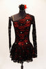 Red shimmery base one shoulder dress has  gathered skirt and black lace overlay with Swarovski accents throughout. The single sleeve and long gauntlet are both sheer black lace and accented with crystals. Comes with a matching red and black hair accessory Front